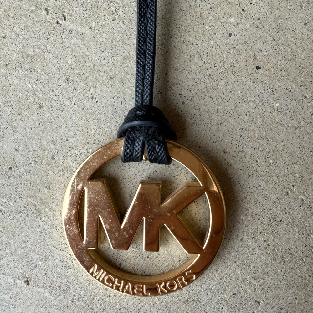 Michael Kors gold and black leather hang tag